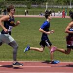 young male athletes running on a track