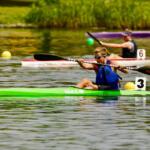 boy rowing green kayak