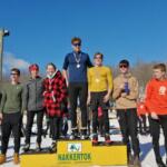 teens displaying awards while standing on dias