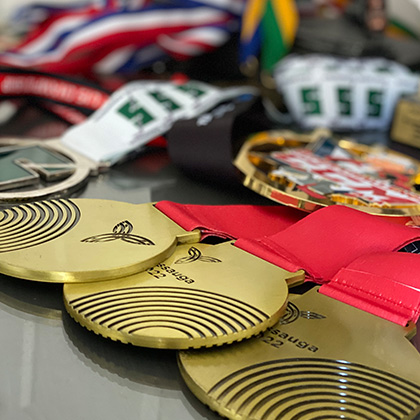 closeup of three gold medals amongst others