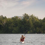 young man in kayak paddling toward us