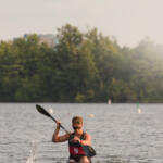 young man in kayak paddling toward us