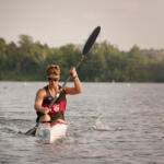 young man in kayak paddling toward us