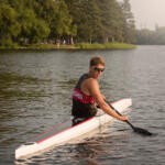 young man in kayak turning to look back