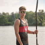 young man holding paddle