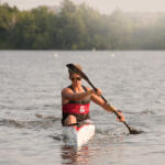 young man in kayak paddling toward us