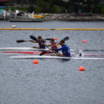 three young men rowing in separate kayaks