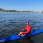 young man in red shirt sitting in blue kayak