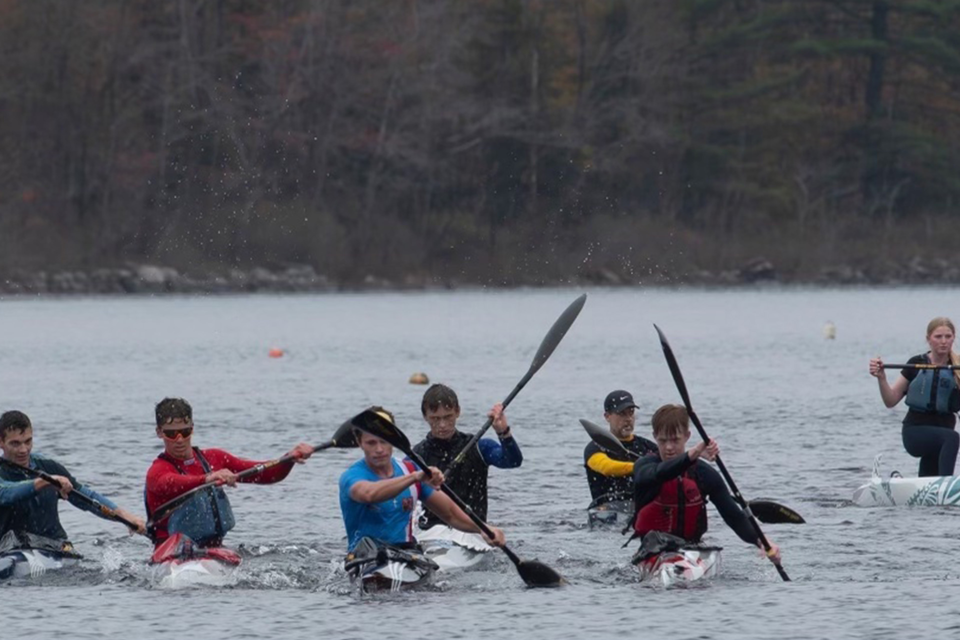 multiple kayakers rowing toward the camera